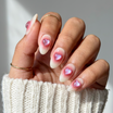 Hand with pink nail polish holding a white sleeve